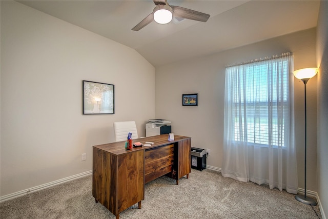 office space with ceiling fan, vaulted ceiling, and light carpet