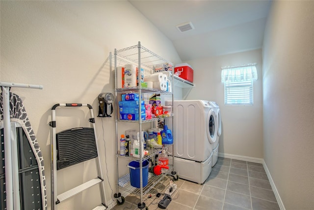 washroom with washing machine and clothes dryer and tile patterned floors