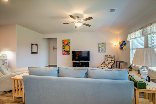 living room with ceiling fan, lofted ceiling, and light hardwood / wood-style floors