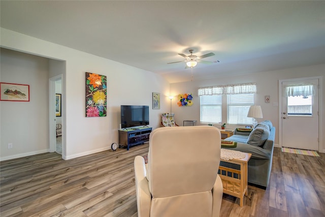 living room with ceiling fan and hardwood / wood-style floors