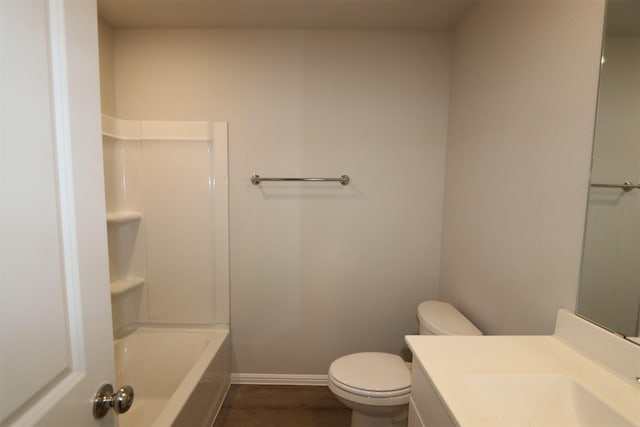 bathroom with toilet, baseboards, wood finished floors, and vanity