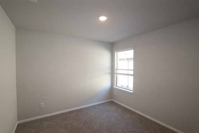 spare room with carpet floors and baseboards