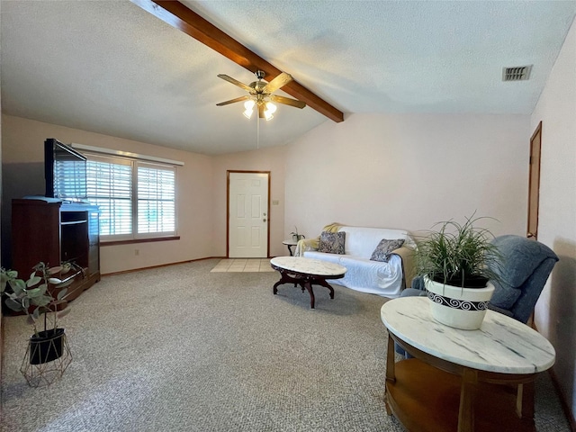 carpeted living room featuring ceiling fan, a textured ceiling, and vaulted ceiling with beams