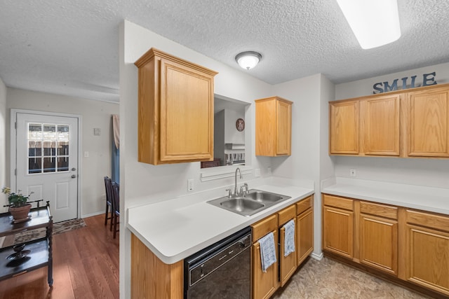 kitchen featuring sink, a textured ceiling, dishwasher, and light wood-type flooring