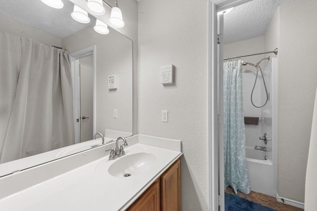 bathroom featuring vanity, a textured ceiling, and shower / tub combo with curtain