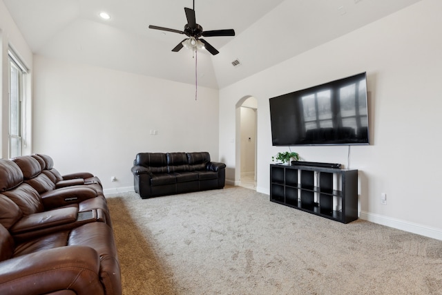 carpeted living room with ceiling fan and vaulted ceiling