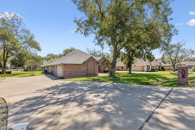 ranch-style house featuring a garage and a front yard