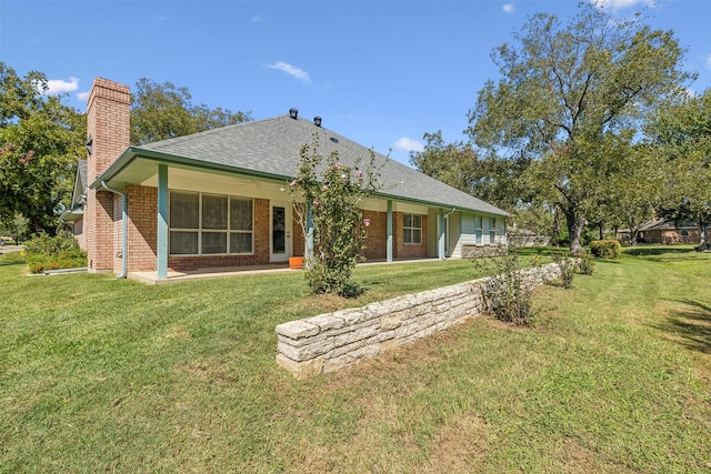 back of house with a lawn