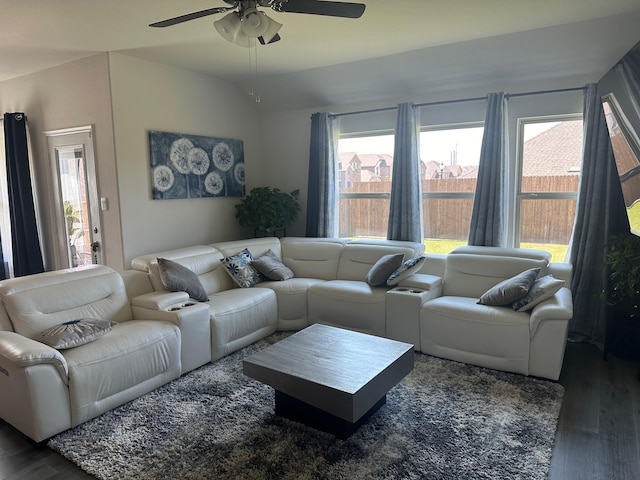 living room with ceiling fan, lofted ceiling, and dark hardwood / wood-style flooring