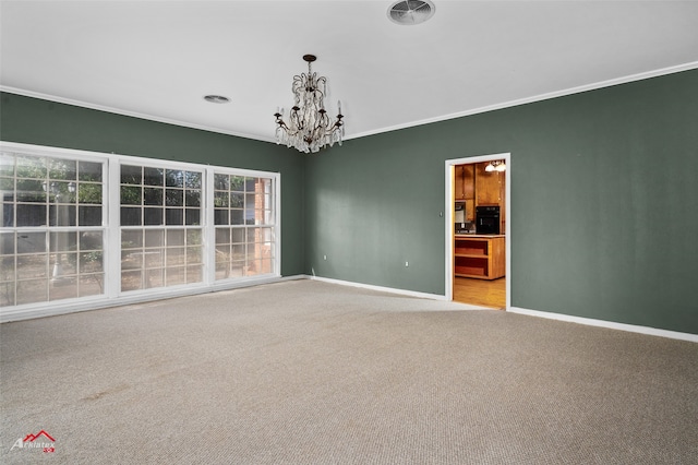 spare room with ornamental molding, light colored carpet, and a notable chandelier