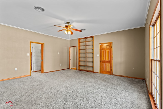 spare room featuring ornamental molding, ceiling fan, and carpet flooring