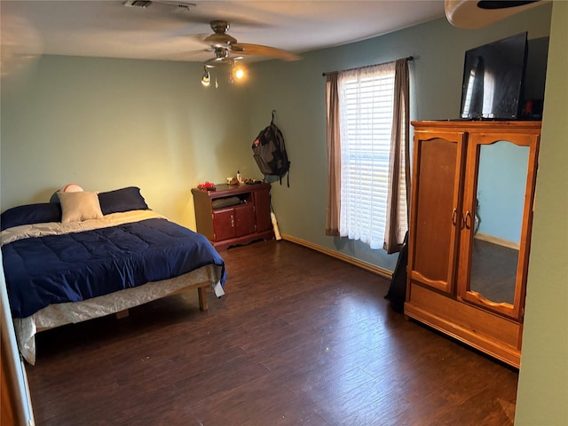 bedroom featuring ceiling fan and dark hardwood / wood-style floors