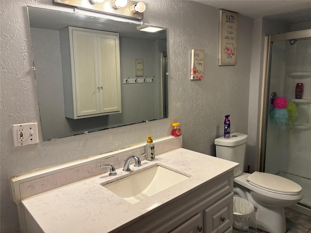 bathroom with walk in shower, vanity, and toilet