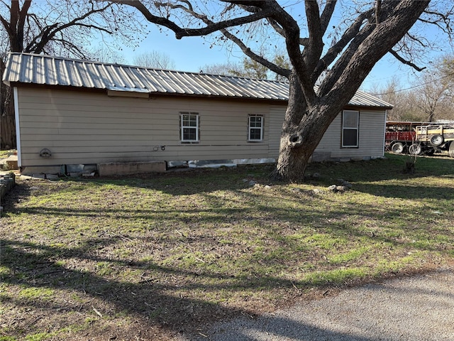 view of property exterior featuring a lawn