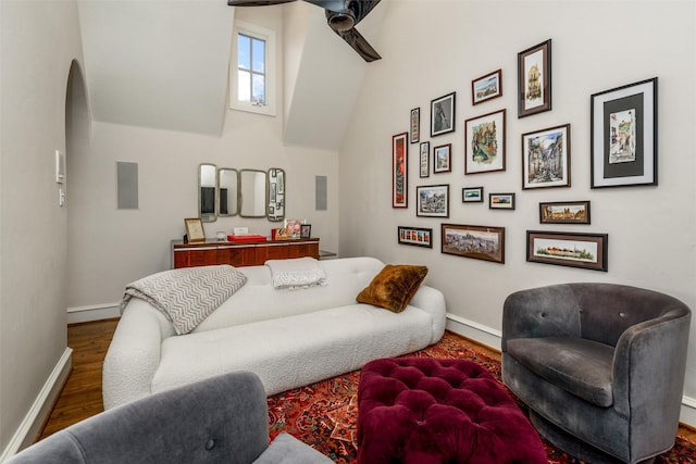living room with dark hardwood / wood-style flooring and ceiling fan