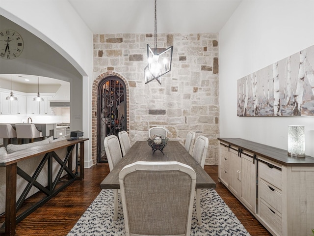 dining room featuring dark wood-type flooring and a notable chandelier