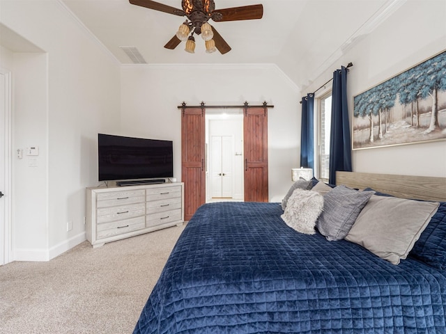 bedroom with vaulted ceiling, ceiling fan, crown molding, a barn door, and light carpet