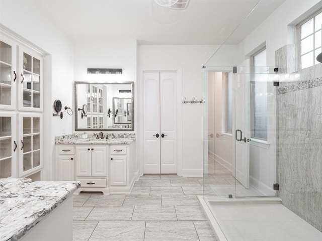 bathroom with vanity and a shower with shower door