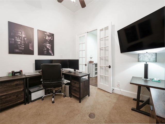 carpeted office featuring ornamental molding, french doors, ceiling fan, and a high ceiling