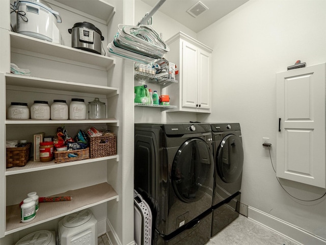 washroom with cabinets and independent washer and dryer