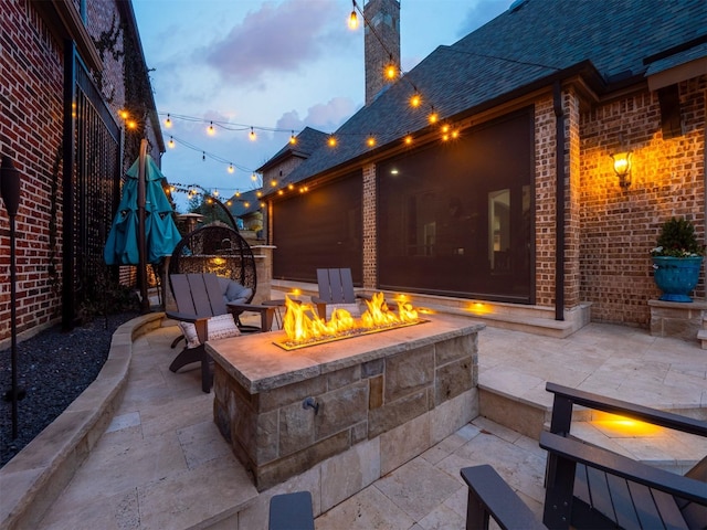 patio terrace at dusk with an outdoor fire pit