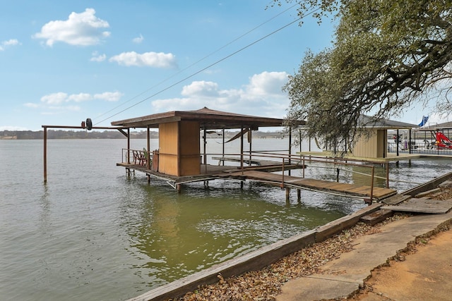 dock area with a water view and boat lift