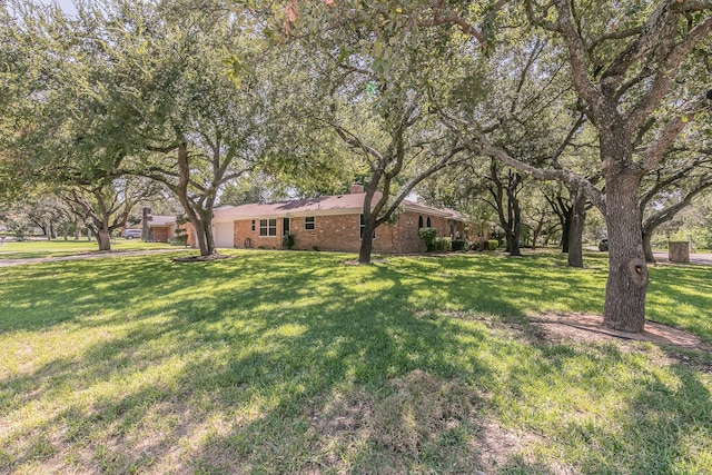 view of grassy yard featuring an attached garage