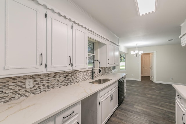 kitchen with dark wood-style floors, black dishwasher, backsplash, white cabinetry, and a sink