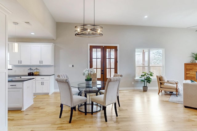 dining room featuring recessed lighting, light wood-type flooring, visible vents, and an inviting chandelier