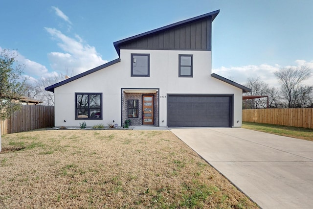 view of front of house with fence, a front lawn, a garage, and concrete driveway