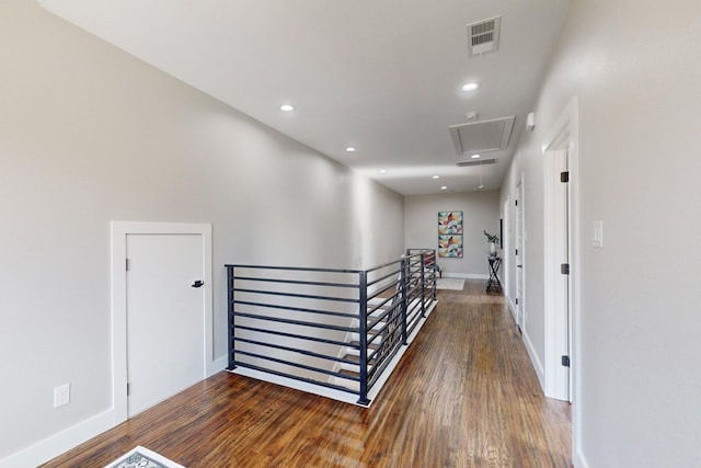 corridor featuring recessed lighting, visible vents, attic access, an upstairs landing, and wood finished floors