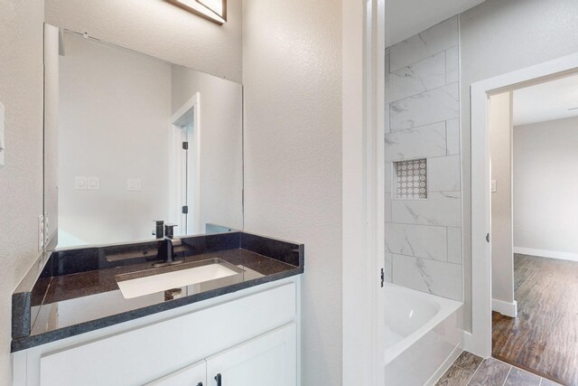 full bathroom featuring baseboards and vanity