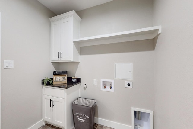 washroom with electric dryer hookup, wood finished floors, baseboards, and gas dryer hookup