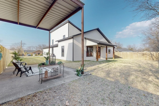 exterior space with a patio area, fence, and a yard