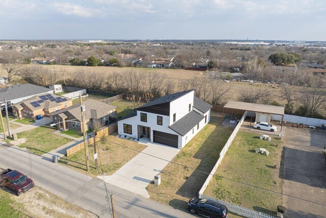 view of front facade featuring a garage, driveway, a front lawn, and fence