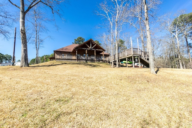 back of house with a yard, a deck, and stairs