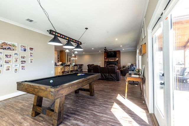 rec room with a fireplace, billiards, visible vents, ornamental molding, and dark wood finished floors