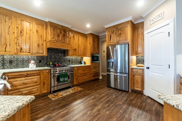 kitchen with stainless steel appliances, dark wood-type flooring, ornamental molding, decorative backsplash, and brown cabinetry