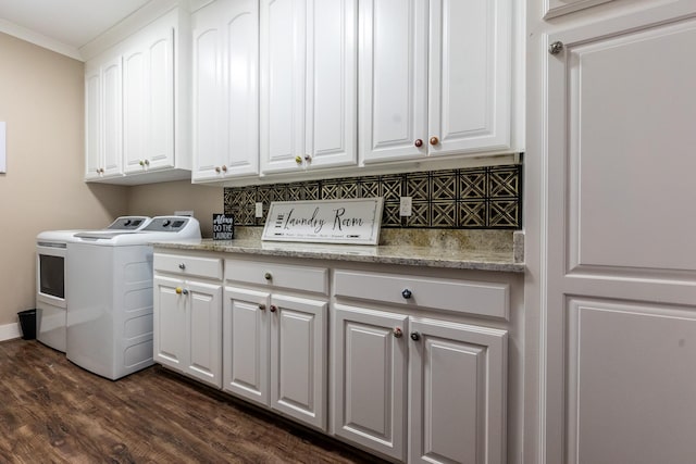 laundry area with dark wood-style flooring, ornamental molding, washer and clothes dryer, and cabinet space