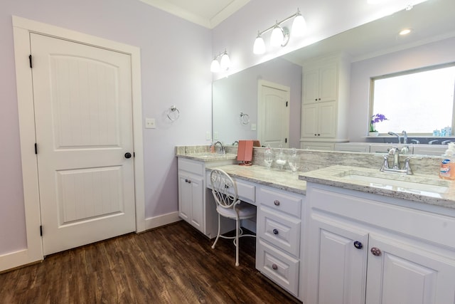 full bath featuring crown molding, double vanity, a sink, and wood finished floors