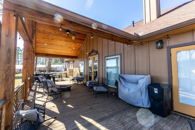 wooden deck featuring ceiling fan and outdoor dining space