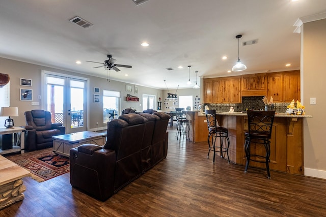 living area featuring french doors, dark wood finished floors, and visible vents