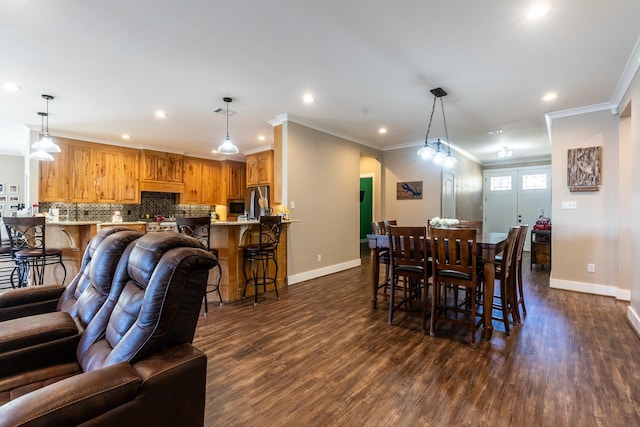 dining area with dark wood-style floors, baseboards, and recessed lighting