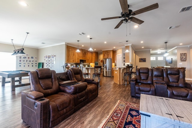 living room with recessed lighting, visible vents, crown molding, and wood finished floors