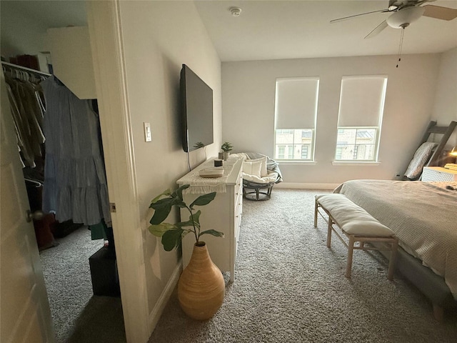 bedroom with a ceiling fan, carpet, and baseboards