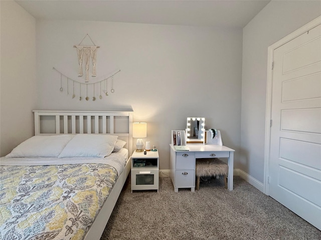 carpeted bedroom featuring baseboards