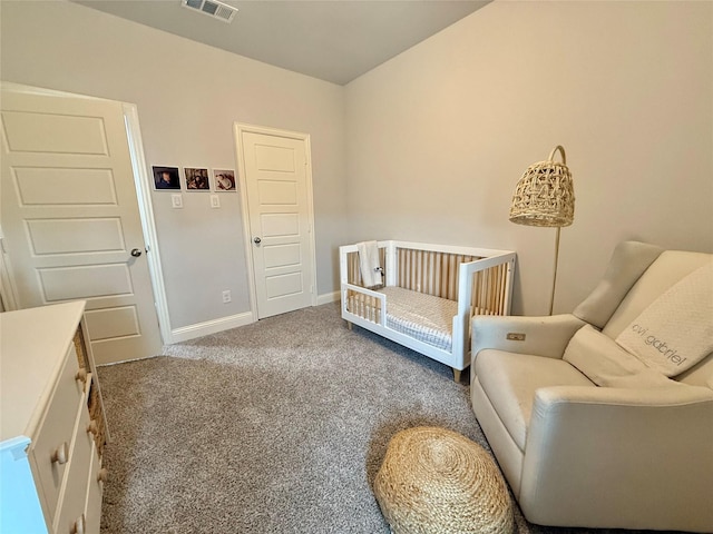 living area with visible vents, baseboards, and carpet flooring