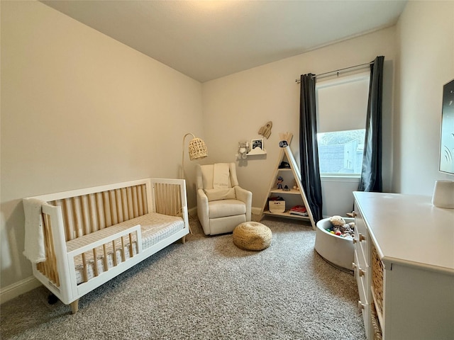 bedroom featuring baseboards, carpet flooring, and a nursery area