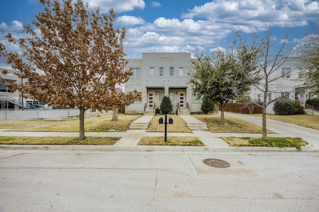 view of front facade with a front yard and fence