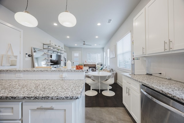 kitchen with dishwasher, hanging light fixtures, visible vents, and white cabinetry